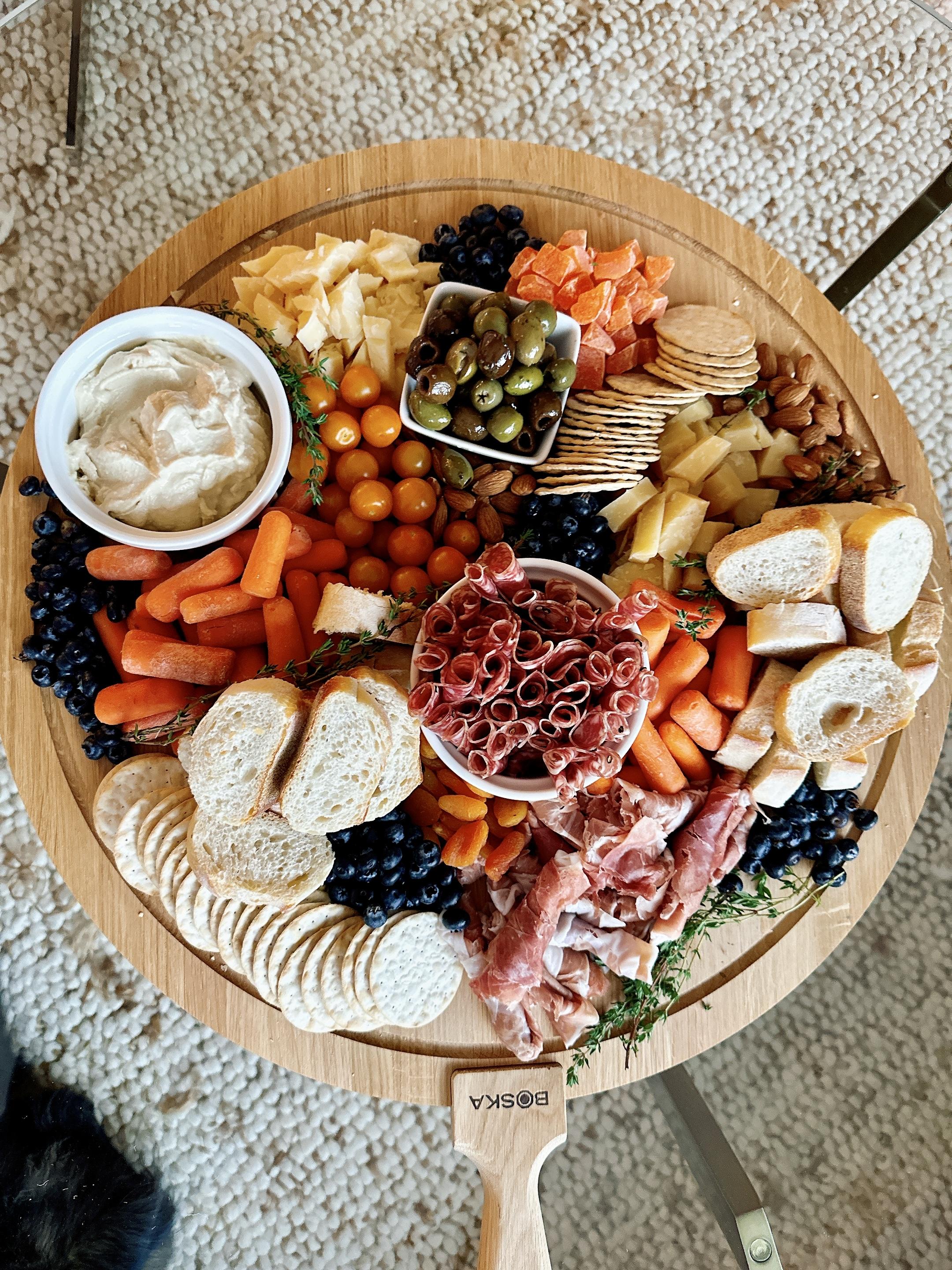 Seasonal grazing board with cheeses, dried fruits, and nuts